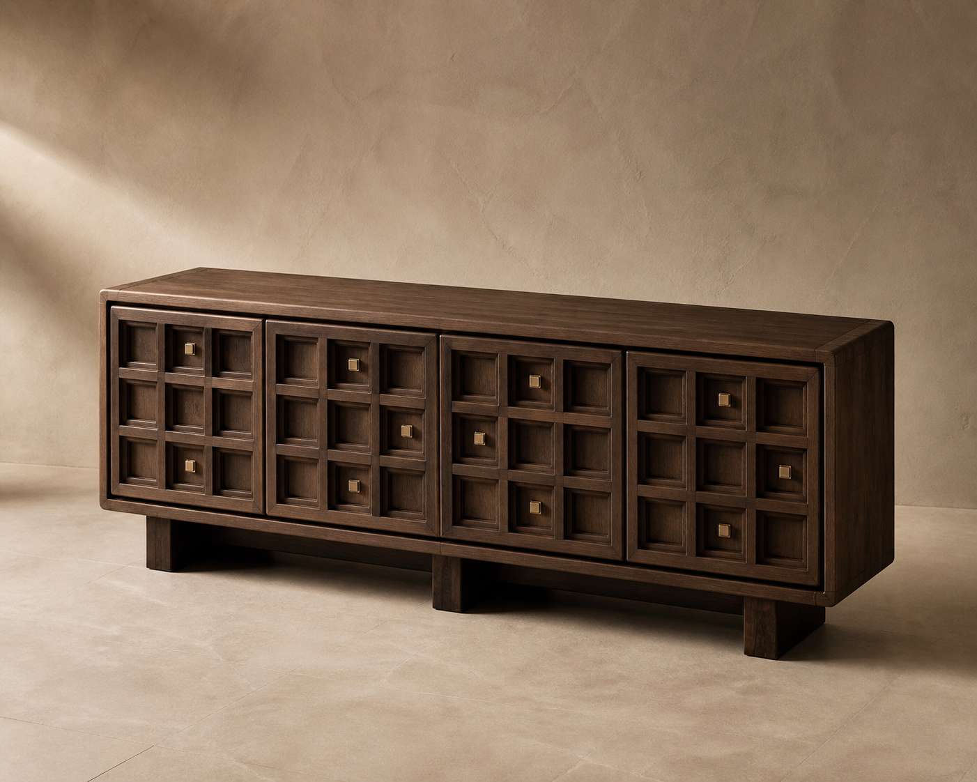 AUTHË v2 canonical studio view — Tactile Grid Credenza in its locked standard configuration, showing four doors and thirty-six hand-carved ash relief modules with a personal bronze datum constellation