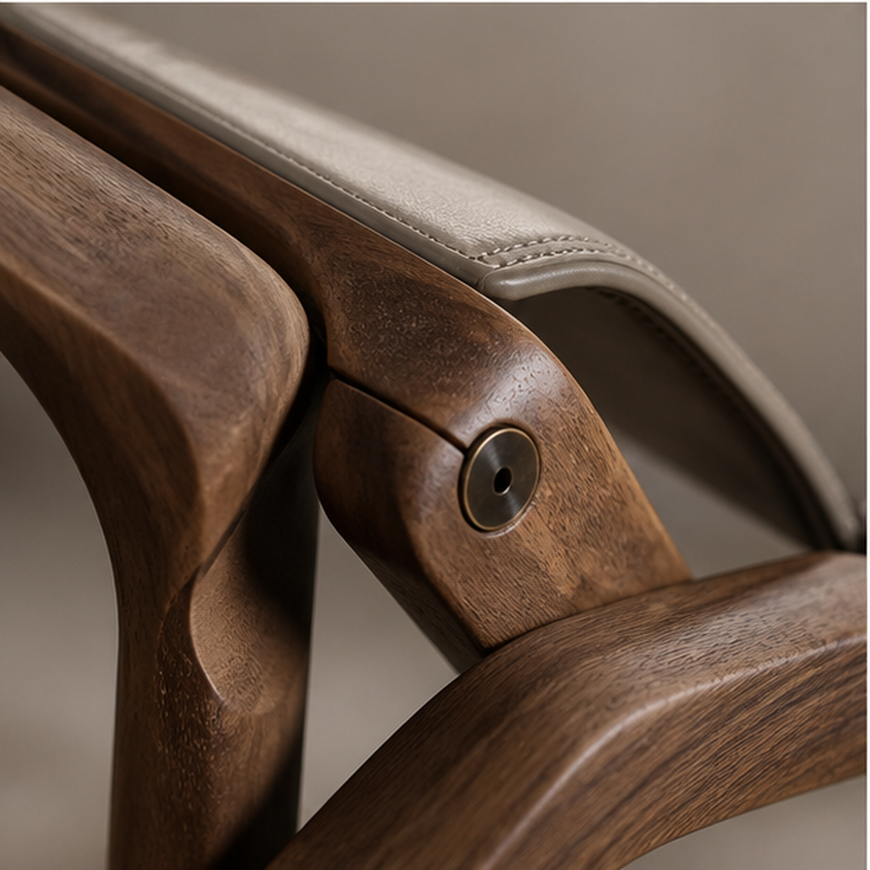 Fold Lounge detail of walnut, saddle-leather edge and bronze pivot